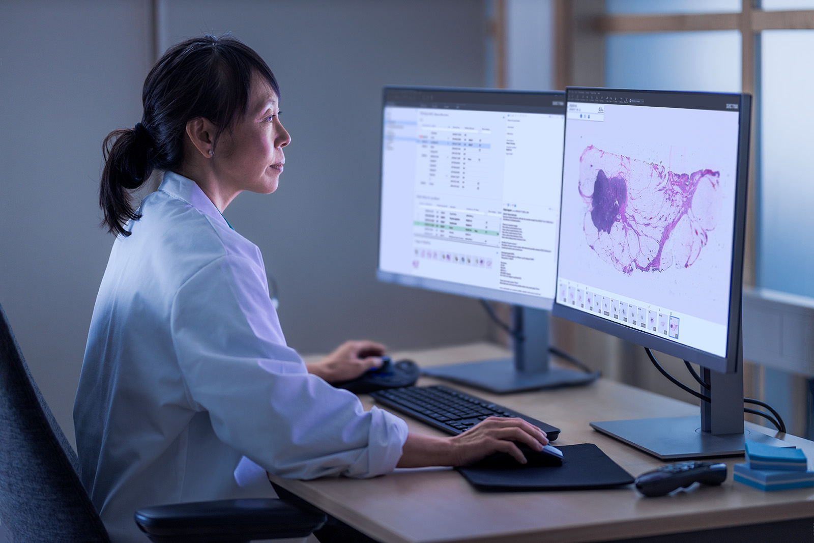 Female pathologist in front of a monitor